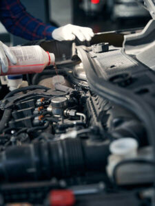 close up photo of man pouring antifreeze